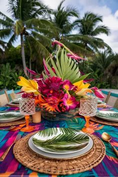 the table is set with colorful flowers and plates