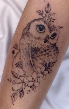 an owl with flowers on its leg