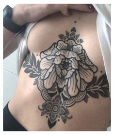 a woman with a flower tattoo on her back