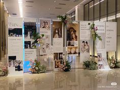 a display with flowers and pictures on it in an airport terminal lobby at night time