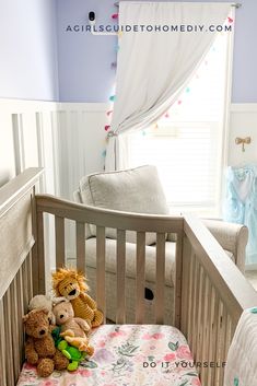 two stuffed animals sitting in a crib