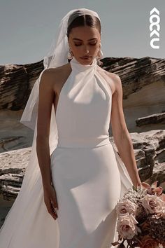 a woman in a wedding dress holding a bouquet