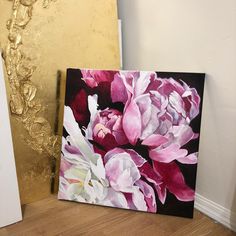 two paintings one with pink and white flowers on it, the other in gold foil