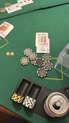 a green table topped with lots of cards and dice