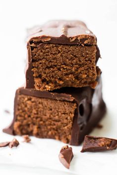 three pieces of chocolate cake sitting on top of each other