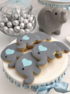 cookies decorated with blue and gray elephants on a table