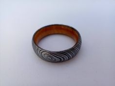 a wooden ring sitting on top of a white table