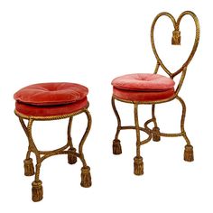 two chairs with heart shaped cushions and tassels on the legs, one is red