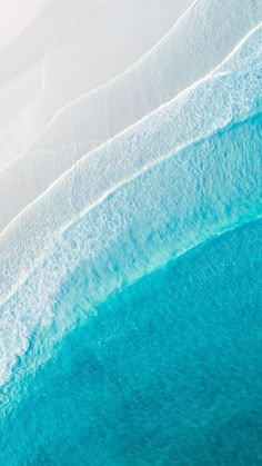 an aerial view of the water and sand