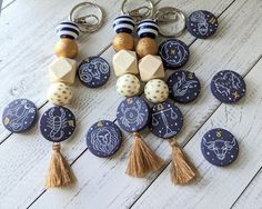 a bunch of buttons with some tassels attached to them on a wooden table