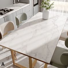 a white marble dining table with chairs around it