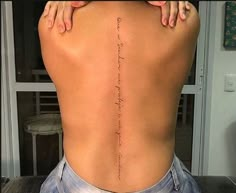 the back of a woman's body with writing on it