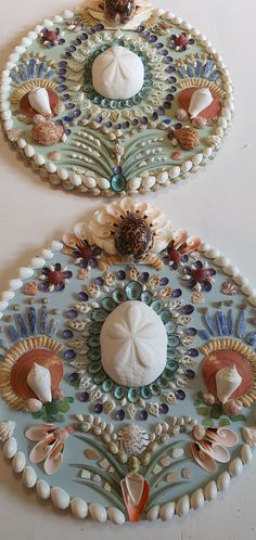 two decorative plates with shells and seashells on them