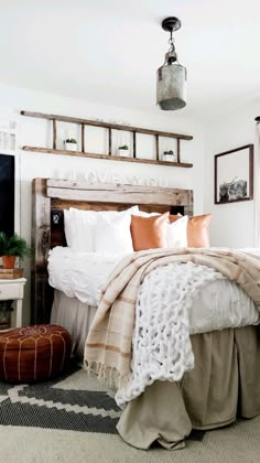 a bed with white sheets and pillows in a bedroom