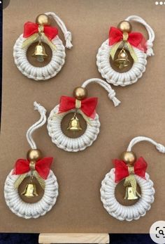 three christmas bells with red bows on them