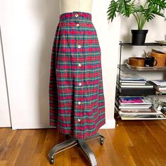 Vintage 1980s cotton plaid skirt by David Brooks. Red, green, yellow, blue and black plaid heavy weight cotton, pleated with a full button side. One on seam pocket. Made in USA. Material / cotton Care / machine wash Please compare measurements to a garment that fits you well for accurate fit. Make allowance for clothes underneath and room to allow garment to drape properly when worn. Mannequin measures 35" - 24" - 34", skirt is clipped on mannequin for proper fit. Size on tag / 14 (fit is closer Plaid Cotton Skirt For Work, Vintage Plaid Cotton Skirt, Retro Plaid Cotton Skirt, David Brooks, Plaid Skirts, Black Plaid, 1980s Vintage, Vintage Cotton, Size 12