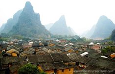 an old village with mountains in the background