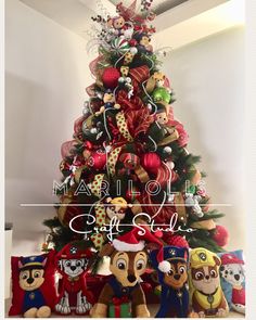 a christmas tree with stuffed animals around it