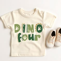 a t - shirt with the words dino four printed on it next to two pairs of shoes