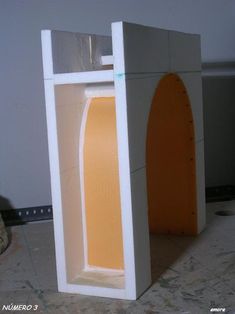 an open white and orange toilet in a room