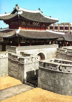 an old chinese building with stone walls and towers