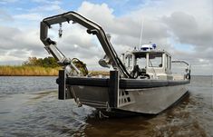 a boat is in the water with its door open and it's front end partially submerged