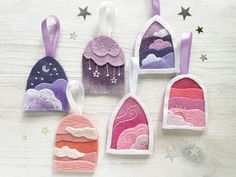 five handmade felt hangings with clouds and stars