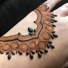 a woman's hand with henna on it