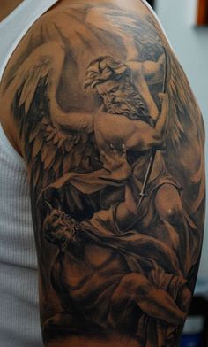 a man's arm with an angel and demon tattoo on the left side of his arm