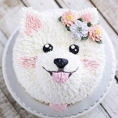 there is a cake that looks like a dog with flowers on it's head