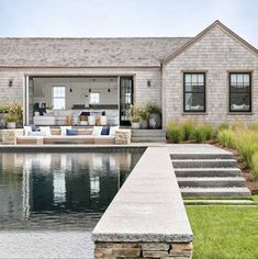 a house sitting next to a swimming pool with steps leading up to the front door