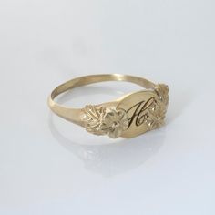 This vintage-inspired floral ring is a series of dainty flowers wrapped around your fingers. Handmade and polished, it is available in 14K gold. This item is engravable with text or monogram of your choice at no extra cost. The initals are engraved onto the ring and embedded in the 3D model for a flawless embossed finish. You may also request for writing on the inside! You may choose to customize this ring with different flowers or letters. Depending on the text used, the flowers may be rearrang Heirloom Birth Flower Jewelry, Vintage Style Gold Flower Promise Ring, Vintage Gold Flower Promise Ring, Vintage Yellow Gold Promise Jewelry, Gold Vintage Style Flower Promise Ring, Vintage Adjustable Initial Ring For Promise, Vintage Adjustable Initial Ring Personalized, Vintage Adjustable Initial Ring, Delicate Engraved Flower Jewelry