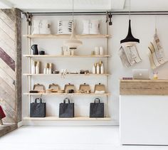 the interior of a store with shelves and bags