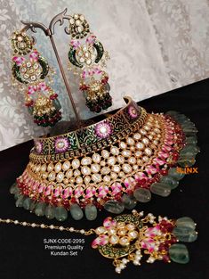 an elaborate necklace and earring set on display