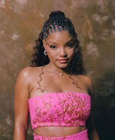 a woman in a pink dress posing for a photo with her hands on her hips