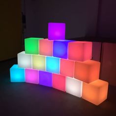 an illuminated wall made out of cubes in the shape of blocks with different colors