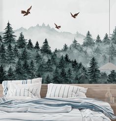 a bedroom with trees and birds painted on the wall