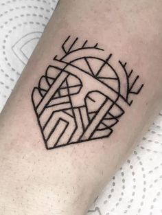 a black and white photo of a tattoo on the arm with geometric shapes in it