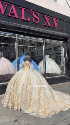 there is a wedding dress on display in front of the store