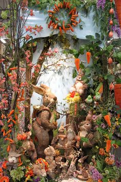 an assortment of stuffed animals and flowers on display