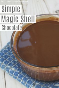 a bowl filled with chocolate on top of a blue cloth next to a wooden table