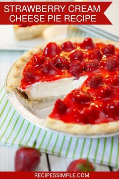 a pie with strawberries on it sitting on top of a table