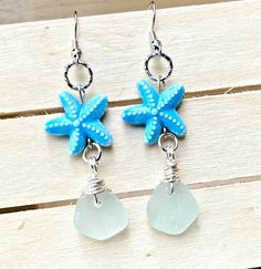 a pair of blue sea glass and starfish earrings