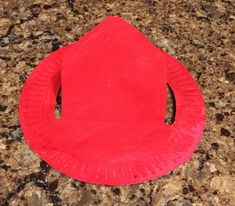 a red paper plate sitting on top of a counter