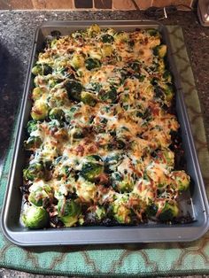 broccoli casserole with cheese and other toppings in a baking pan