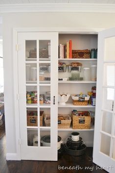 an open pantry door with baskets and food in it