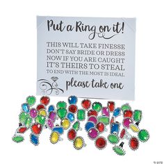 a bunch of pins sitting next to a sign that says put a ring on it