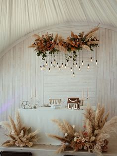 the table is set up with flowers and pamodia in front of it, along with candles