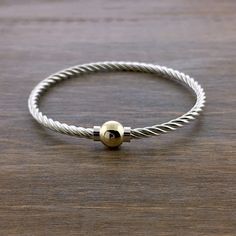 A nice "twist" on the traditional smooth Cape Cod bracelet! Features two separate silver pieces wound together for a unique look and added flexibility. Available in all sterling silver, two tone - sterling and solid 14k gold, or all 14k gold.  Please email to order all gold - special order and will take longer to ship