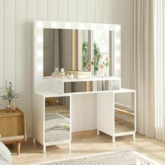 a white vanity table with lights on it in a room next to a bed and window